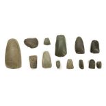 A GROUP OF NEOLITHIC STONE AXES Most with rounded cutting edge and tapering butt, with examples in