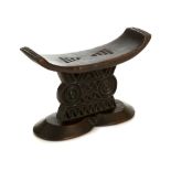 A SHONA WOODEN HEADREST Carved in relief with different geometric designs on both sides of the