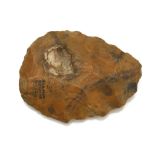 A PALAEOLITHIC CARAMEL-COLOURED FLINT HAND AXE With an ink inscription indicating it was found in