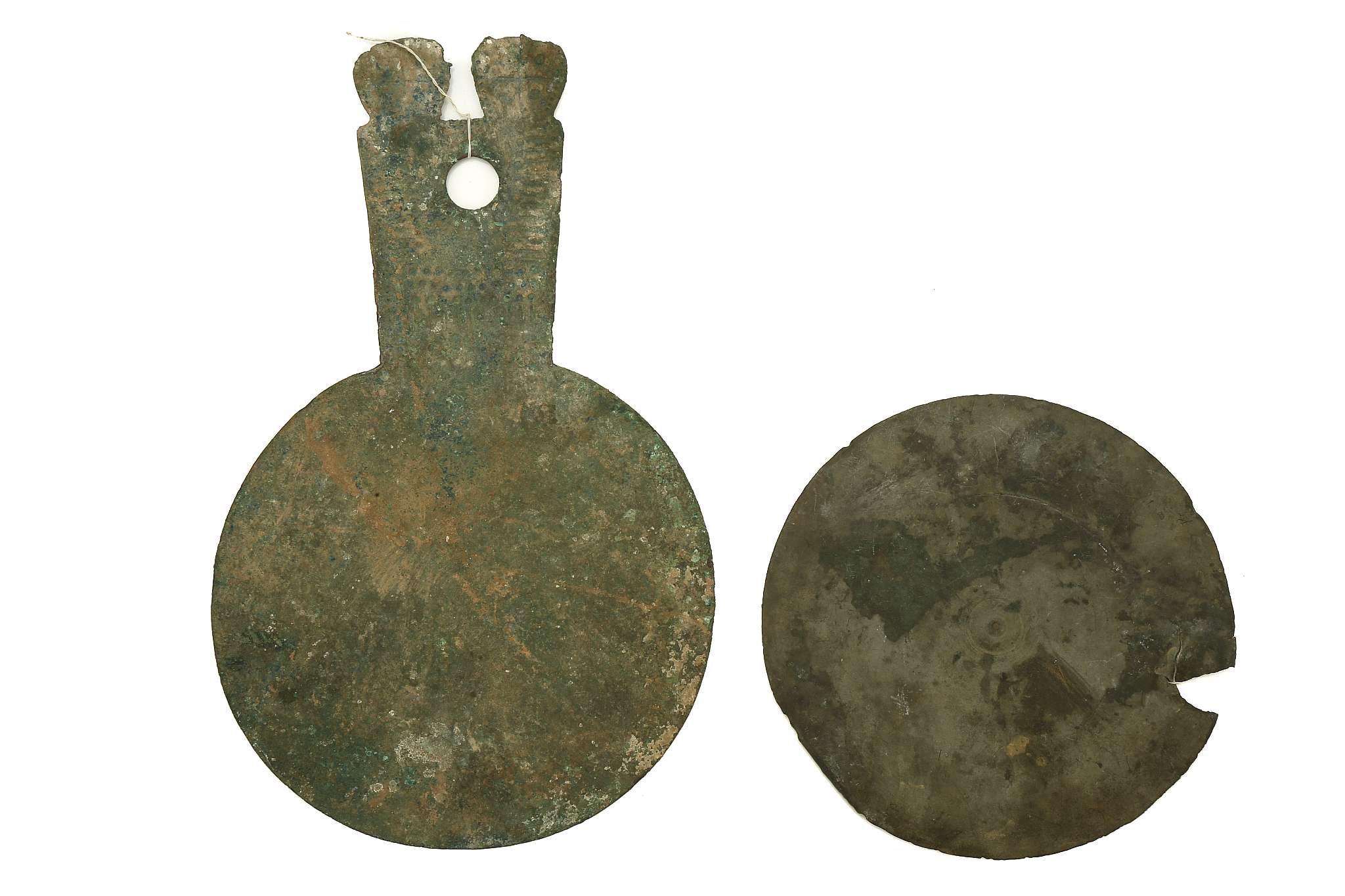 A LURISTAN BRONZE MIRROR AND A ROMAN BRONZE MIRROR Circa 10th Century B.C.-3rd Century A.D. The