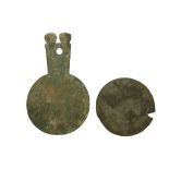 A LURISTAN BRONZE MIRROR AND A ROMAN BRONZE MIRROR Circa 10th Century B.C.-3rd Century A.D. The