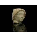 A ROMAN BRONZE HEAD OF A MAN Circa 2nd Century A.D. With the hair arranged in snail curls across the