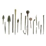 A GROUP OF BRONZE PINS, IMPLEMENTS AND ARROW HEADS Circa 10th Century BC to Roman Period Including a