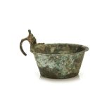 A ROMAN BRONZE BOWL Circa 2nd-3rd Century A.D. The bowl with sloped sides and an everted rim, the