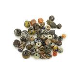A GROUP OF GLASS AND HARDSTONE BEADS Circa 2nd Millennium B.C. to Islamic Period and later Including