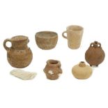 A GROUP OF ANCIENT POTTERY VESSELS Including an Egyptian terracotta Bes beaker, 6.8cm high,