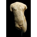 A ROMAN MARBLE TORSO OF A MAN Circa 2nd-3rd A.D. Depicted nude, standing in contrapposto with his