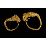 TWO HELLENISTIC GOLD EARRINGS Circa 4th-3rd Century B.C. Each with a twisted hoop, hooked into a