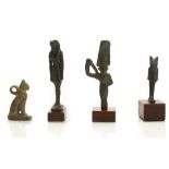 FOUR EGYPTIAN BRONZE AMULETS Late Period, circa 664-332 B.C. A cat in the seated position, 26th