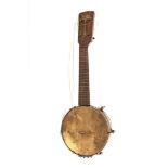 An old banjo ukulele. It has a wooden body.