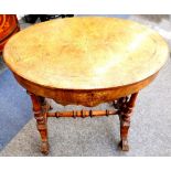 A Victorian inlaid oval walnut work table, on turned twin end standards.