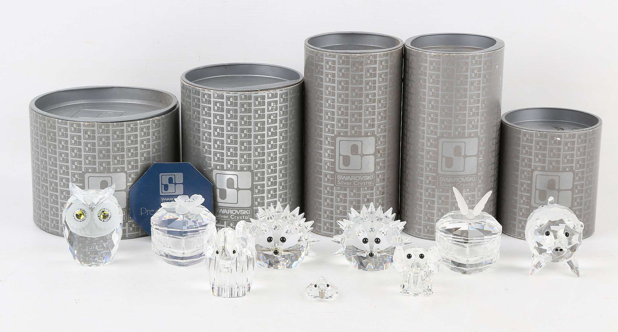 A collection of Swarovski silver crystal figures of animals, including a pair of hedgehogs, an