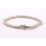 A 14ct white gold diamond line bracelet, channel set, total weight: 6.86cts.