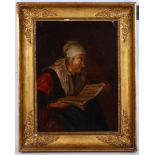 Circa late 18th Century Dutch school. Oil on canvas interior, an old lady reading. In period