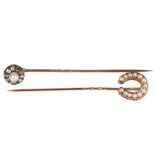 Two stick pins, 1st: Set with a seed pearl horseshoe, cased 2nd: Set with a bouton pearl within a