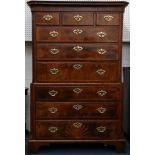 A George II walnut chest on chest, fitted with two short and six long crossbanded drawers, flanked