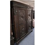 An 18th Century design, Italian walnut cabinet, enclosed by two carved panelled doors, with