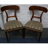 A set of four early 19th Century German walnut dining chairs with curved crest rails, on square