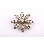 An early 20th Century yellow and white gold, seed pearl and old cut diamond flower head brooch.