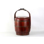 A Chinese red lacquer three section wedding basket, the cover decorated with figures among clouds,