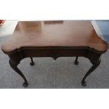 A George II mahogany folding card table, the baize lined interior with counter wells, over a