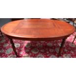 A reproduction 19th Century colonial style oval dining table, with faux planked top on turned