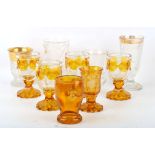 Two 19th Century Bohemian amber overlaid etched glass beakers, decorated with 'Health, Wealth,