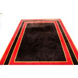A LARGE MODERN 100% WOOL, CUSTOM MADE, HAND TUFTED RUG, in red, black and mustard borders, (3.2m x