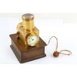 An unusual early 20th Century brass projection timepiece, with top lens and cord illuminator, 15cm