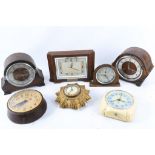 Seven Smiths electric and mechanical timepieces, majority oak cased.