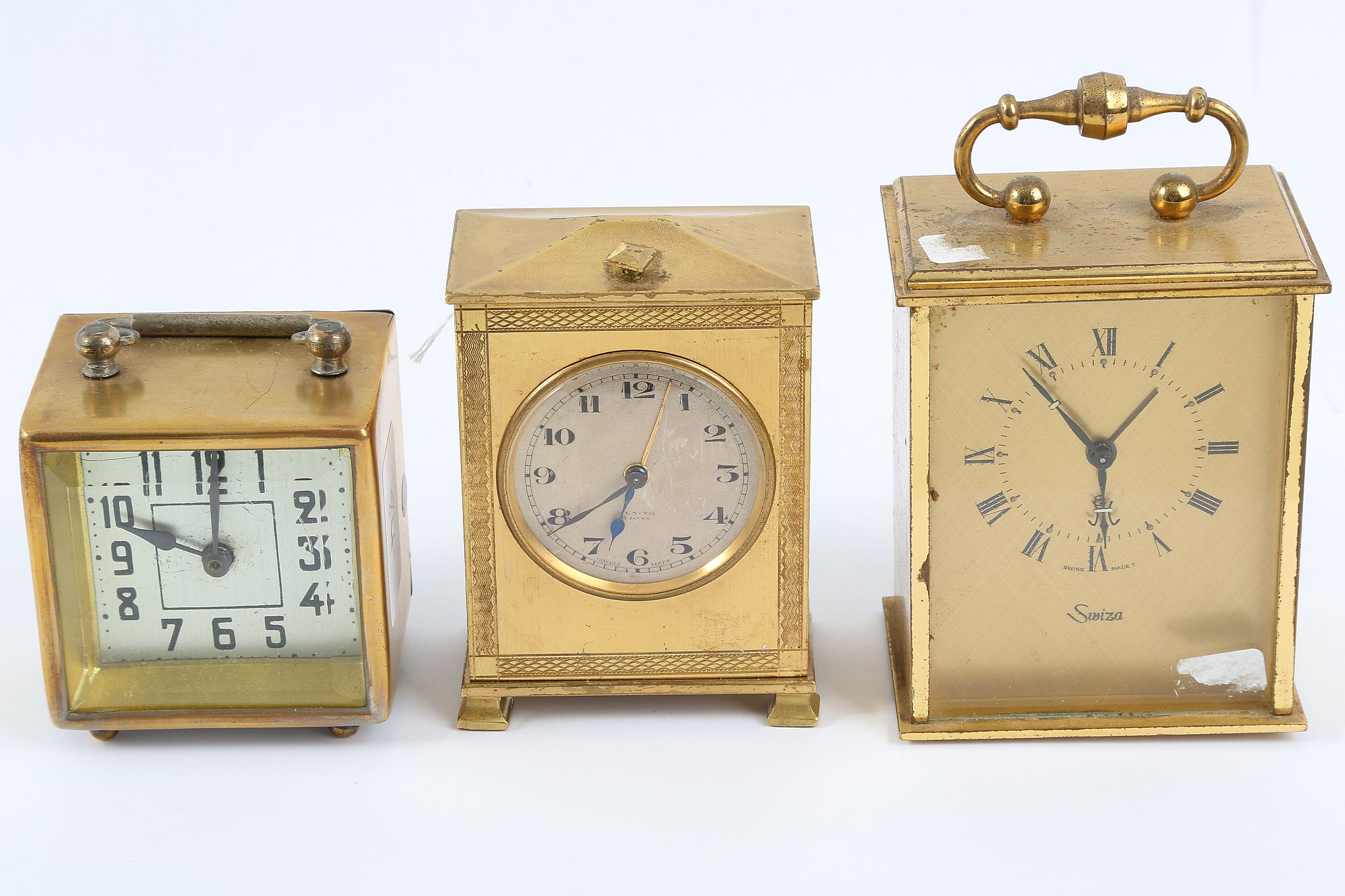 A Zenith Watch Company, gilt brass bedside alarm timepiece and two other brass timepieces.