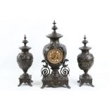 An early 20th Century French bronzed metal clock garniture, in Chinese taste, cast with dragons, the