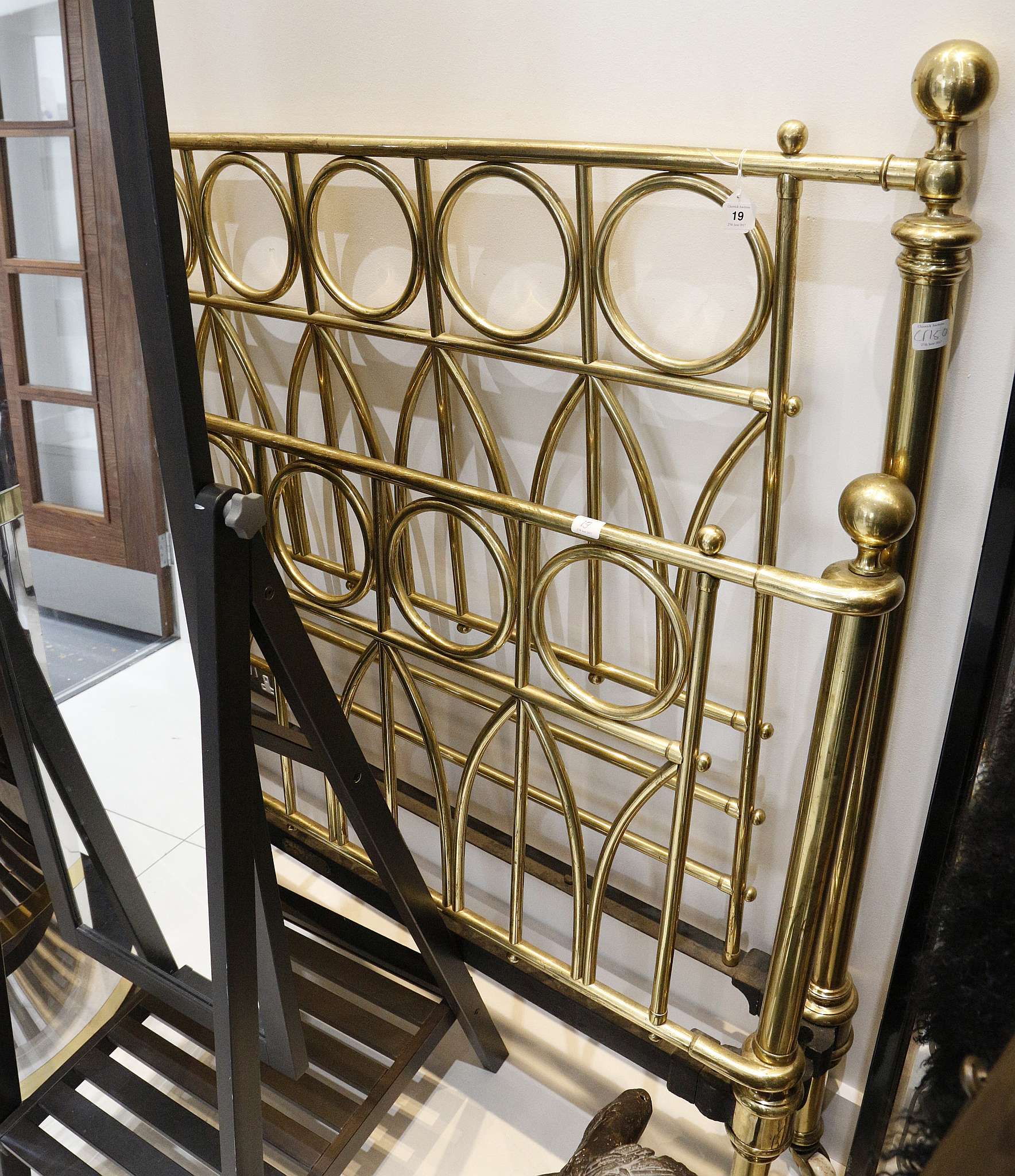 An early 20th Century Gothic revival style, heavy brass and cast iron bed, 143cm high.