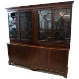 A George III design, mahogany library bookcase enclosed by 4 astragal glazed doors, over panelled