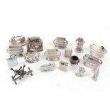 A collection of silver plated and chrome table and pocket lighters, three Victorian knife rests,