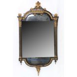 A 19th Century French ebonised, parcel gilt, wall mirror with column frame, 108cm high. 47cm wide.