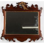 A 19th Century mahogany wall mirror, with rectangular bevelled glass, surmounted by a gilded