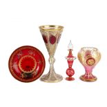 A set of four late 19th Century Bohemian and Venetian cranberry flashed gilded glassware, to include