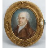 Circa late 18th Century. Pastel portrait in the oval of a man with powdered wig and brown coat. In a