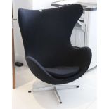 A contemporary black fabric egg swivel chair, on 4 prong base.
