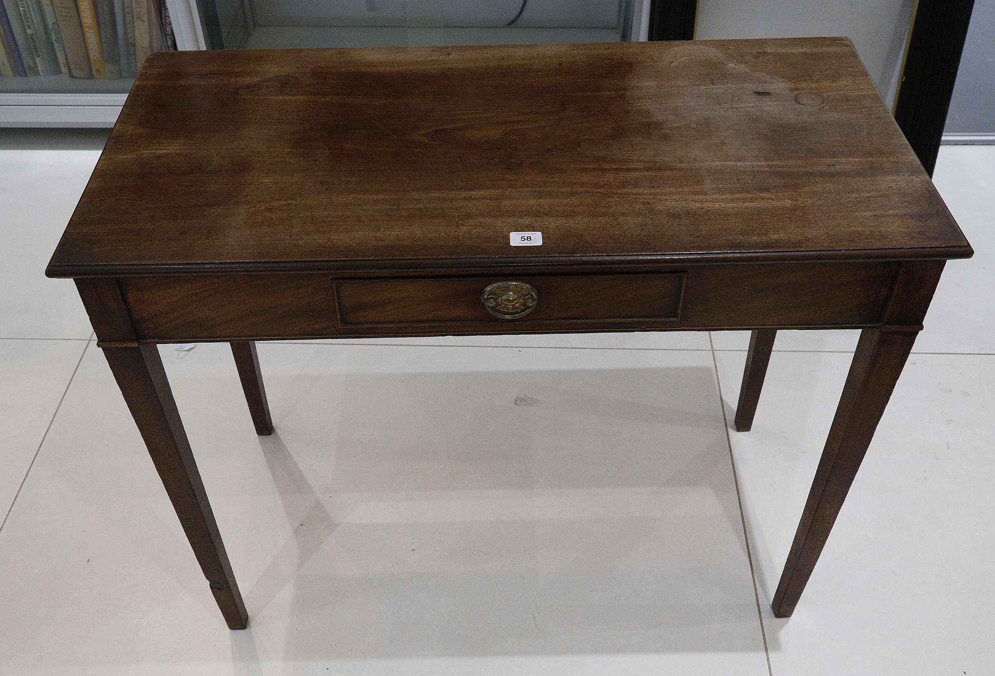 A 19th Century side table with single drawer, supported on square tapered legs, and a 19th Century