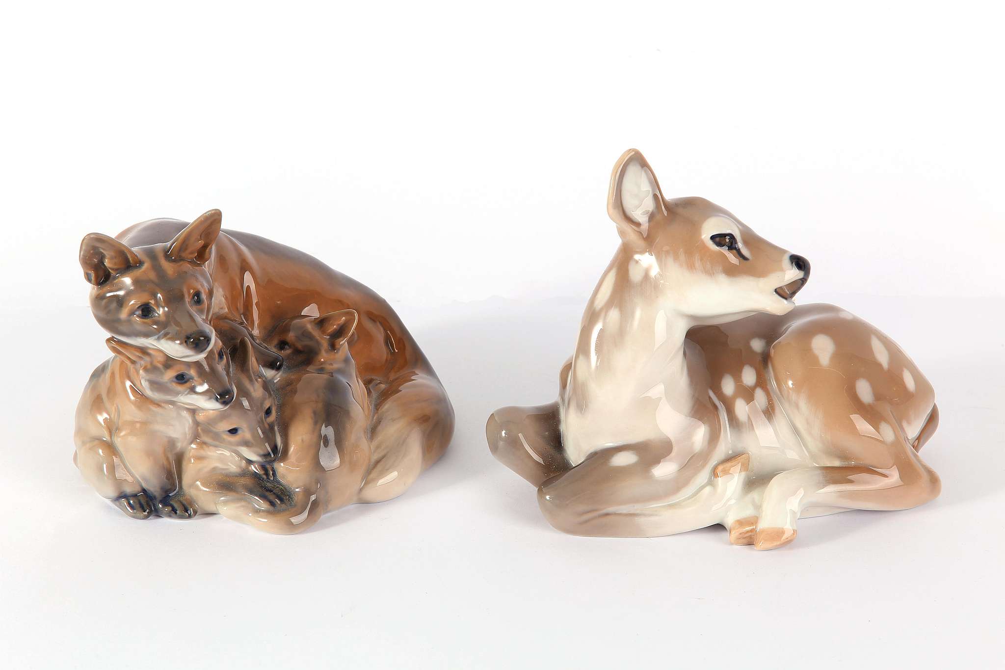 A Royal Copenhagen figural group of fox and cubs, model no.1788, designer HF, sold with a model of a