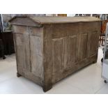 A large antique 17th Century oak dome top chest - coffer, with panelled hinged lid, raised on