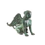 After the antique, a green patinated bronze of a seated sphinx, 46cm long.