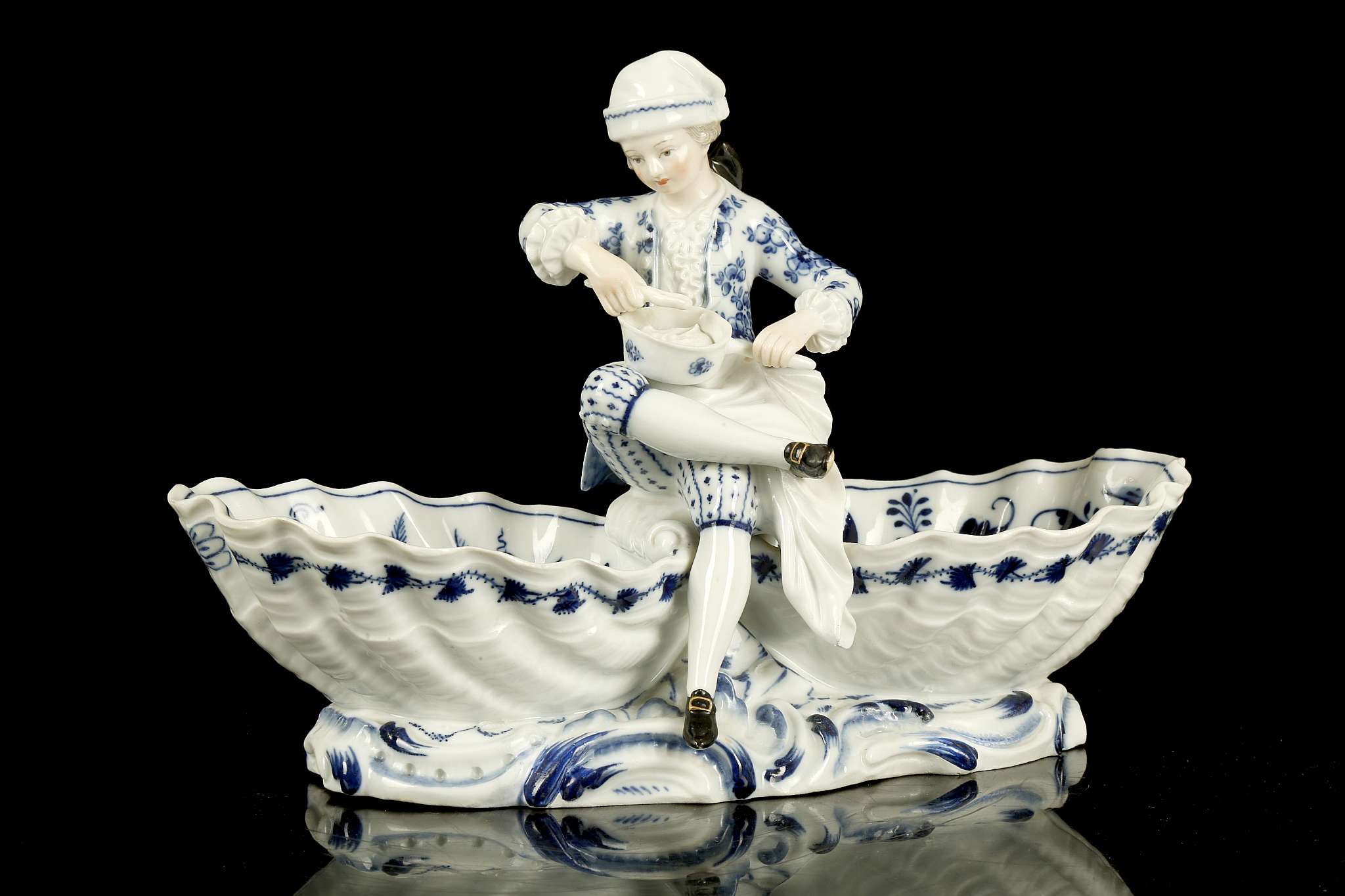 A MEISSEN PORCELAIN FIGURAL SWEETMEAT DISH, late 19th century, modelled as a young cook wearing a