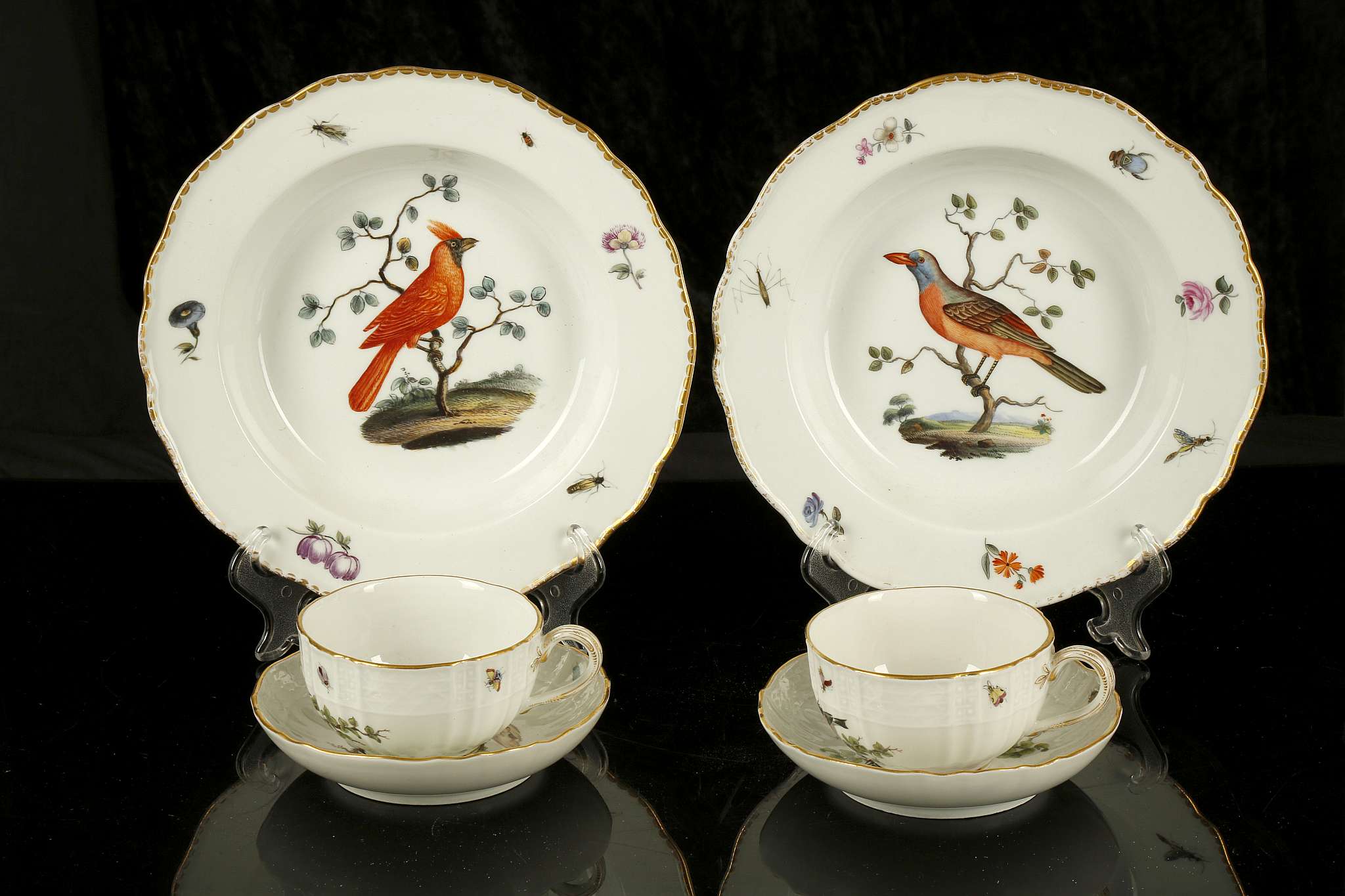 A PAIR OF MEISSEN PORCELAIN ORNITHOLOGICAL TEA CUPS AND SAUCERS, late 19th century, painted with