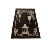 AN UNUSUAL CHINESE RUG CIRCA 1920 approx: 5ft.10in. x 4ft.1in.(178cm. x 124cm.) The charcoal-brown