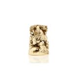 A SMALL IVORY OKIMONO OF A MAN ON A HORSEBACK. Meiji period. Carved from a single block, depicting