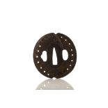 AN IRON TSUBA. Edo period. Modelled as an abalone, signed Akahana Yoshitsugu, with a wooden fitted