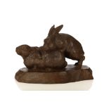 A WOOD OKIMONO OF TWO HARES. 20th Century. Carved from one single block wood, one recumbent while